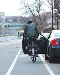 Cyclist collides with door