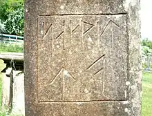 Runic script on an 1886 gravestone in Parkend churchyard.