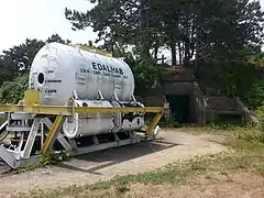 EDALHAB, an underwater habitat used for saturation diving experiments in Lake Winnipesaukee in the late 1960s, now located outside the Seacoast Science Center. Battery 204, a former 6-inch gun battery, is in the background.