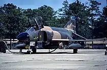 A U.S. Air Force F-4 Phantom II pictured at Tinker Air Force Base. On its intake splitter-plate is a kill mark in the form of a red star, signifying an aerial victory achieved during the Vietnam War.