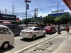 Vehicles on F. Llamas Street heading towards N. Bacalso Avenue