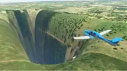 Screenshot of a blue plane approaching an abyss at a grass field.