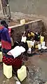 People in Uganda filling up water canisters (here around 5-20 L).