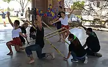 Photograph of male and female Tinikling dancers