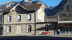 Two-story stone building with gabled roof