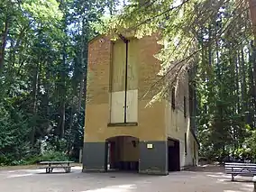 Abandoned brick structure surrounded by forest