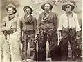 A group of "dudes" posing in chaps and stetsons, c.1910