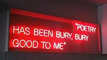 Poet Ron Silliman's neon sculpture From Northern Soul (Bury Neon) is displayed at the entrance to Bury Interchange.