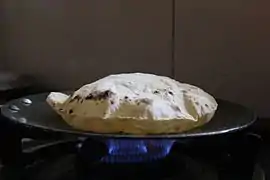 A roti being baked on a tava