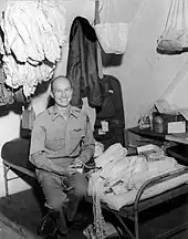  Halvorsen sitting on a cot in barracks surrounded by handkerchiefs to be made into parachutes