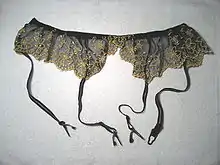 A garter belt showing suspenders attached to the bottom