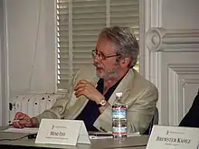 Nunberg seated at a table