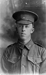 A head and shoulders portrait of a junior ranking soldier. He is looking off to the left.