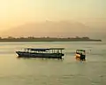 View from Gili Trawangan; in the foreground are island hopper boats anchored off Gili Trawangan, Gili Meno is the next island — Ginung Rinjani is in the distance