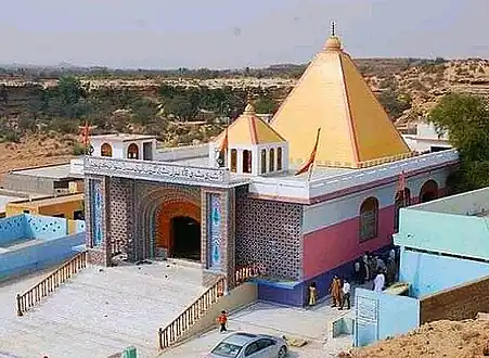 Large, square building with a gold pyramidal roof