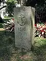 The historic stone which was once erected in the Barracks area, now on the lawn outside the Flagstaff House