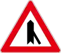 Joining the side road at a sharp angle to the right