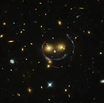 "Smiley" image – galaxy cluster (SDSS J1038+4849) & gravitational lensing (an Einstein ring) (HST).