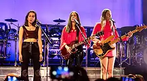 Haim performing in April 2018From left to right: Alana, Danielle, Este Haim