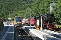 A tram-train at a railway station