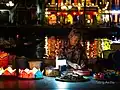 An old lady is selling water lanterns in Hội An