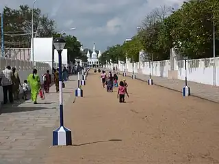 Pilgrims walking on their knees towards the pond