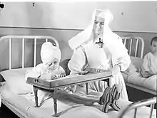 Child and a nun at the hospital, 1945