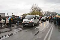 The funeral caravan is greeted by people at the Ternopil city limits