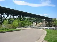 the bridge painted green and the street below it