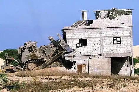 An IDF D9N (2nd generation armor) razing a house during the Second Intifada