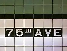 White and green tile mosaic spelling out the station name