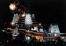 Iskcon temple at night with fireworks