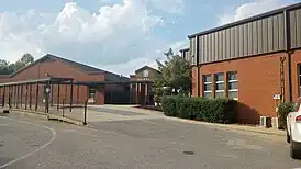 Image of the main entrance to Isabella High School. Pictured is a breezeway connecting two academic buildings. The front facade of the breezeway displays "Isabella" and bears a coat of arms.