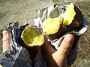 Stone baked potatoes wrapped in newspaper is a common style.