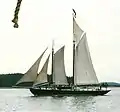 Gaff rigged schooner J. & E. Riggin. Her sails, from left to right, are: jib, staysail, gaff foresail, gaff mainsail, and, above that, a main gaff topsail