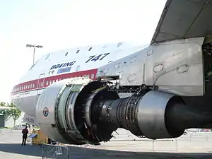 The Pratt & Whitney JT9D turbofan suspended under the wing pylon of the 747 prototype. It is stripped of its outer casing, revealing the engine's core at The Museum of Flight in Seattle, WA