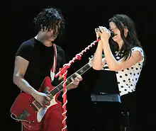 Colour photograph of Jack and Meg White performing live in 2007