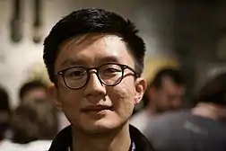 Photograph of Jack Cheng amid an outdoor crowd