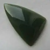 A freeform triangular cabochon of olive-green Wyoming nephrite jade.