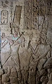 Taharqa, followed by the sistrum shaking queen Takahatenamun in the Jebel Barkal Temple of Mut