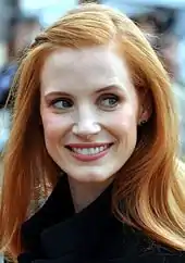 Jessica Chastain smiles while she gently looks away from the camera