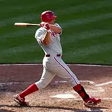 Thome has swung through a pitch during a day game wearing his gray Phillies uniform.