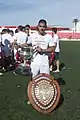 Joseph Chipolina holding plaque commemorating club's Rock Cup victory