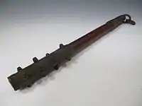 A small antique Japanese wooden club with iron-covered ends and iron studs (ararebō).