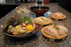 Various types of sushi with green shiso leaves