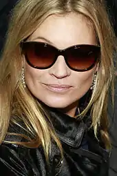 Kate Moss wearing sunglasses & a black jacket