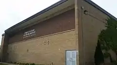 Kenner Collegiate exterior built with brown brick masonry and name mounded in metal letters.