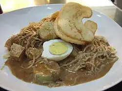 Ketoprak, vegetables, tofu, rice vermicelli and rice cake in peanut sauce.