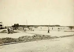 c. 1900–1910 a drying area: One firing pile is being prepared; another is under way.