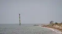 Kiipsaare Lighthouse seen from South with the tip of Kiipsaare Nukk visible in the background, 2023